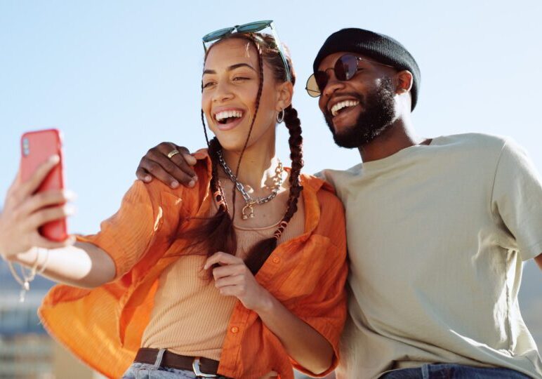 A man and woman are smiling for the camera.