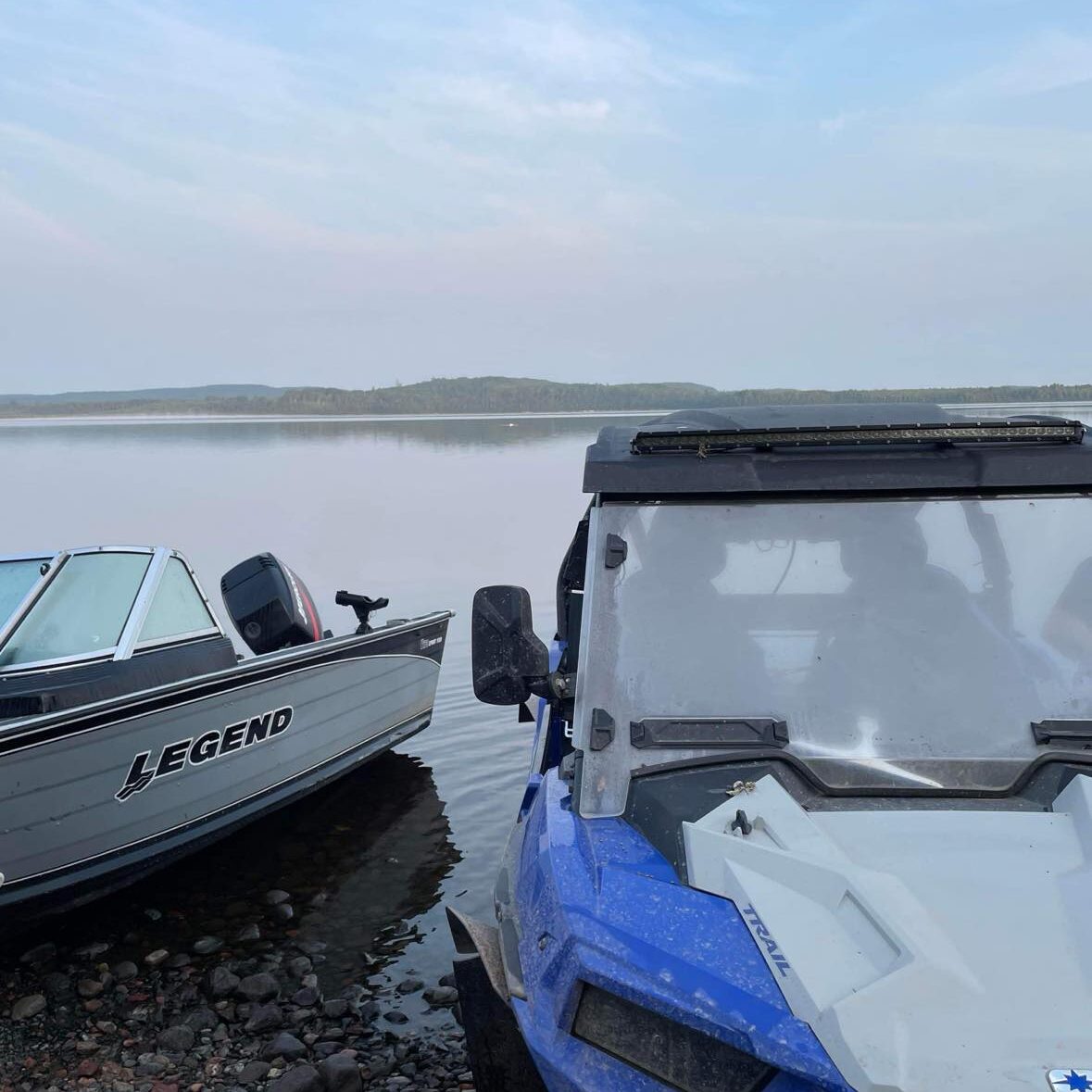 mine A boat and a truck are parked on the shore.